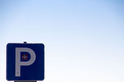 Information sign against clear blue sky