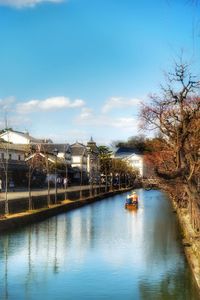 Boats in river with buildings in background