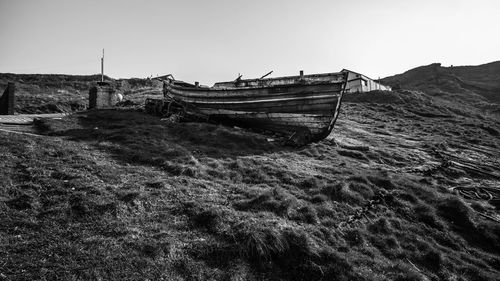 Abandoned boats on beach against sky