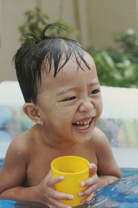 Close-up of cute boy in swimming pool