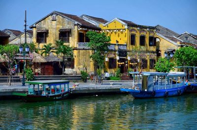 Boats in canal with buildings in background