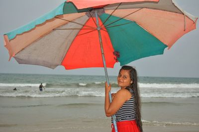 Full length of woman standing on beach