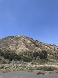 Scenic view of mountains against clear blue sky