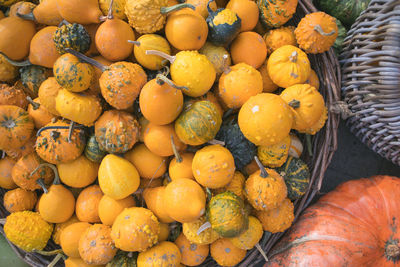 High angle view of oranges in basket for sale at market stall