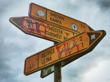 Low angle view of road sign against sky