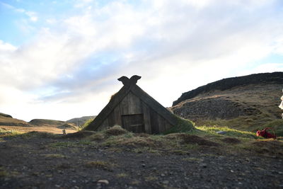 Building on field against sky