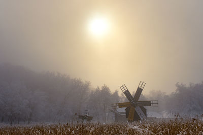 Old authentic traditional wind mill on a cold fogy day