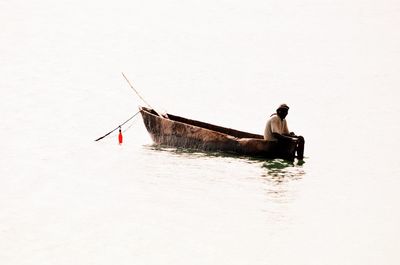 Bird on boat in sea