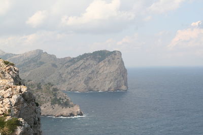 Scenic view of sea and mountains against sky