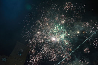 Low angle view of firework display at night