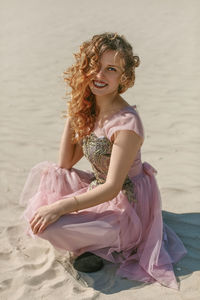 Young woman sitting at beach