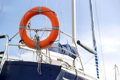 Sailboat and orange lifebuoy , selective focus