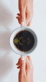 Midsection of person holding tea cup