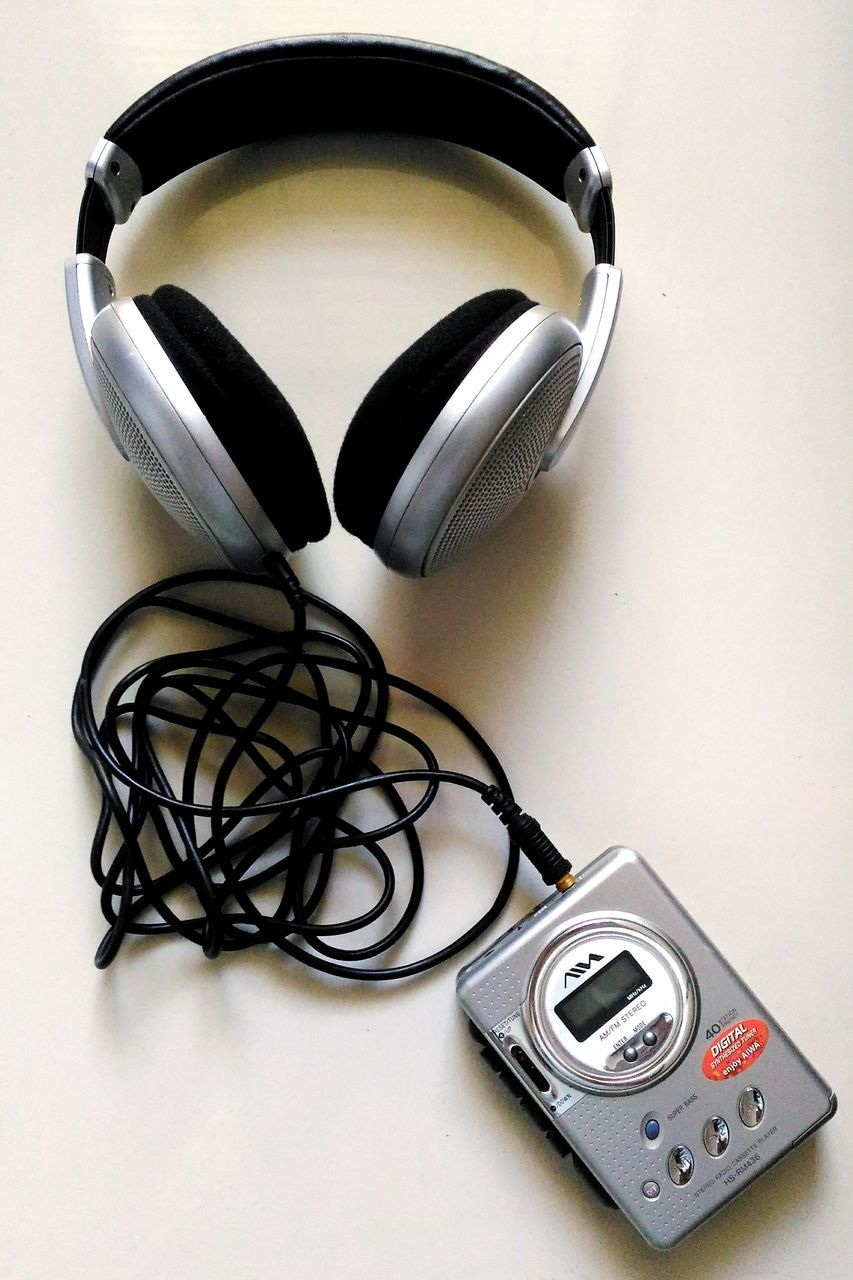 technology, table, indoors, cable, electricity, no people, headphones, camera - photographic equipment, close-up, white background, day