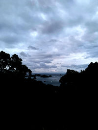 Scenic view of silhouette trees against sky at dusk