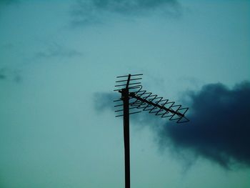 Low angle view of crane against sky