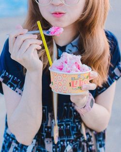 Midsection of woman holding ice cream