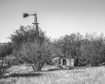 Traditional windmill on field against clear sky