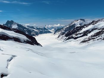 Scenic view of snow covered mountains against sky