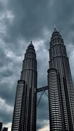 Low angle view of buildings against cloudy sky