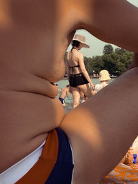 Full length of shirtless young woman in bikini