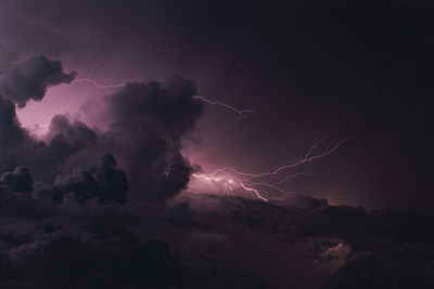 Low angle view of lightning against sky at night