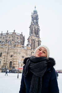 Portrait of woman against dresden cathedral in city during winter