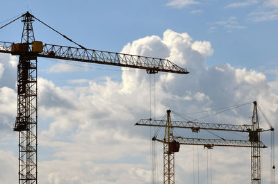 Low angle view of crane against sky