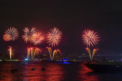 Low angle view of firework display at night