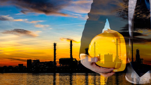 Digital composite image of building against sky during sunset