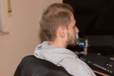 Musician looking at computer in recording studio