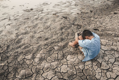 High angle view of boy relaxing on land