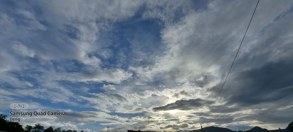 Low angle view of road sign against sky