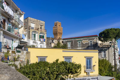 Low angle view of buildings against blue sky