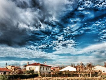 Buildings against cloudy sky