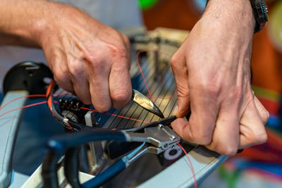 Cropped hands of man repairing car