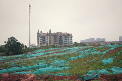 Buildings in city against clear sky