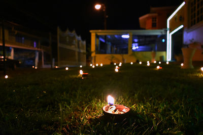 Close-up of illuminated lamp at night