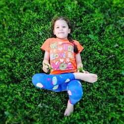 Portrait of cute girl standing on field
