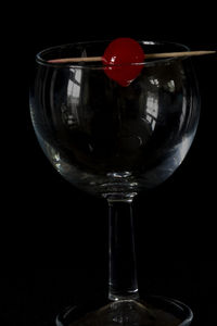 Close-up of beer glass against black background