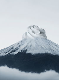 Digital composite image of mountain and ice cream against sky