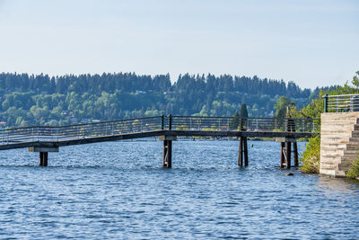 A pier spans water at gene coulon park in renton, washington.