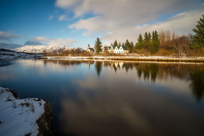 Scenic view of lake against sky during winter