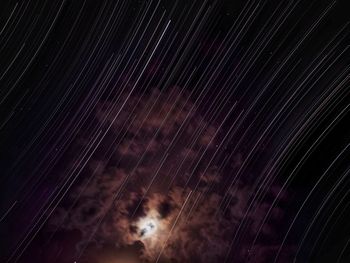 Low angle view of light trails at night