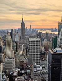 Aerial view of buildings in city during sunset