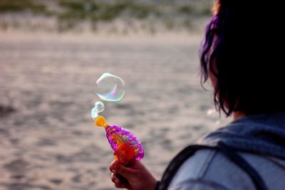 Portrait of woman holding bubbles