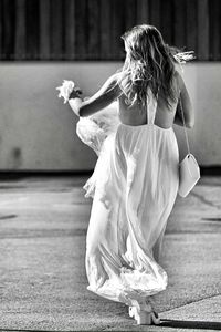 Rear view of woman dancing outdoors