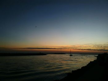 Scenic view of sea against sky at sunset