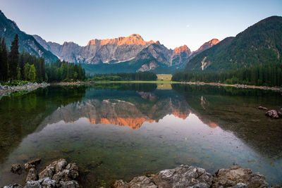 Scenic view of lake and mountains against blue sky