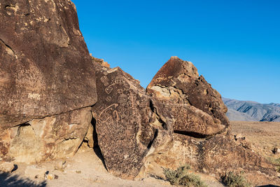 Ancient petroglyph symbols inscribed in rock face  by indigenous peoples of owens valley california
